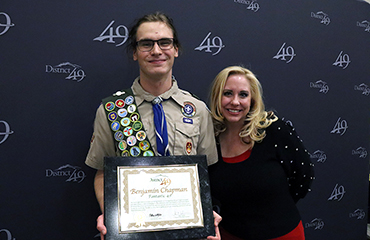 Rebekah Lusk, counselor at BRES, helps honor Benjamin Chapman, student at FHS, during Fantastic 49.